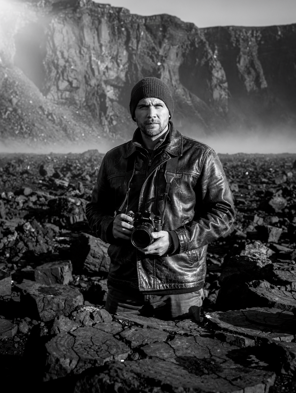 Landscape photographer conducting field survey amidst volcanic terrain