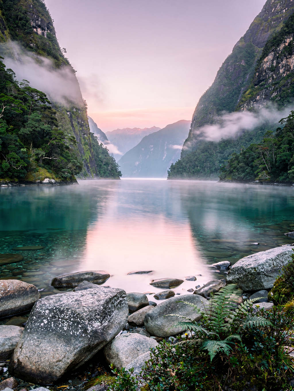 Monolithic peak rising from calm fjord waters